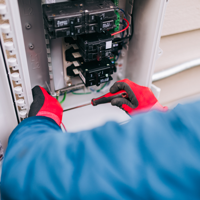 someone repairing an electrical panel